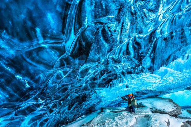 istock Tourist discovering the ice cave 928992766