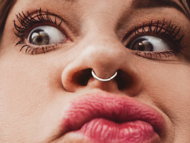 Close up of woman with real septum piercing Close up of woman with real septum piercing septum piercing stock pictures, royalty-free photos & images