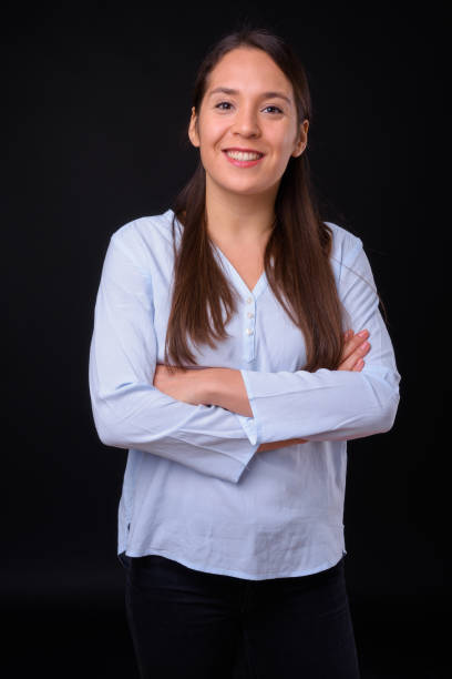 istock Young beautiful multi-ethnic businesswoman against black background 929003752