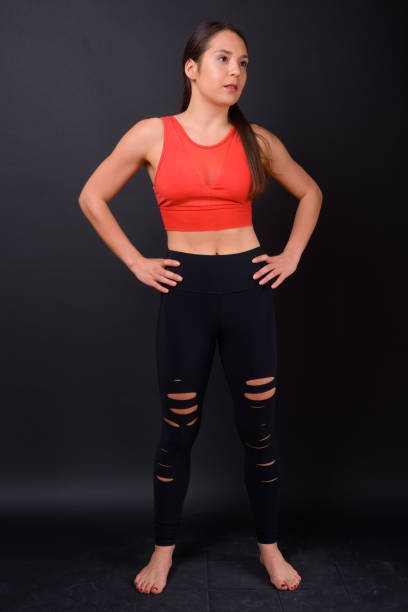 istock Young beautiful multi-ethnic woman ready for gym against black background 929008138