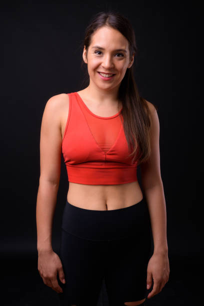 istock Young beautiful multi-ethnic woman ready for gym against black background 929008268