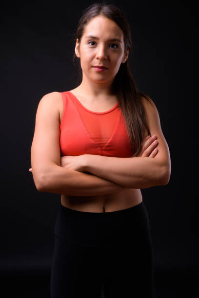 istock Young beautiful multi-ethnic woman ready for gym against black background 929008300