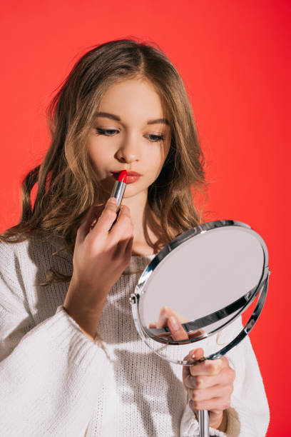 istock teenage girl applying makeup 929015884