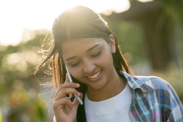 istock Young woman talking on her cell phone at the park 929016210