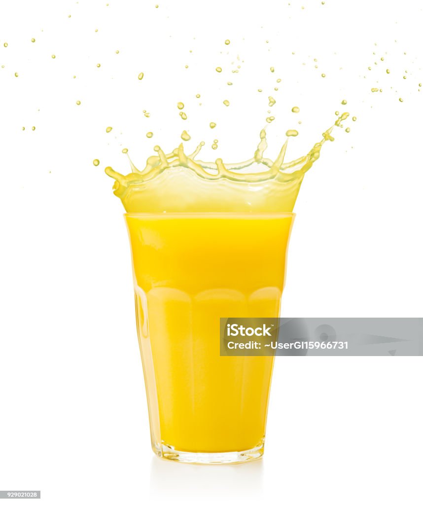 fruit juice glass splashing isolated on white yellow juice spilling out of a glass isolated on white Juice - Drink Stock Photo