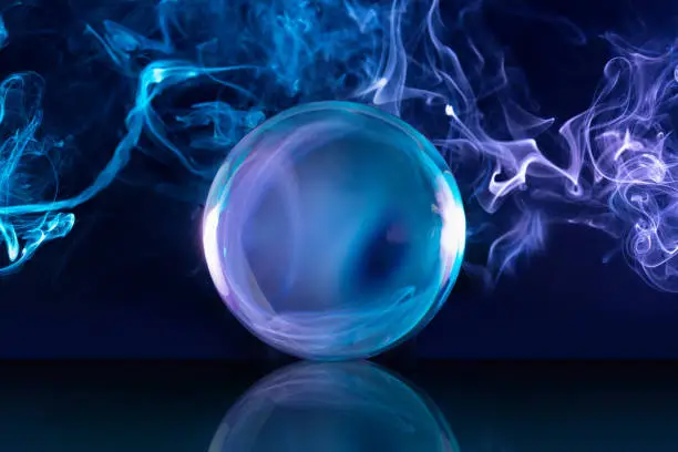 Photo of crystal ball in smoky background