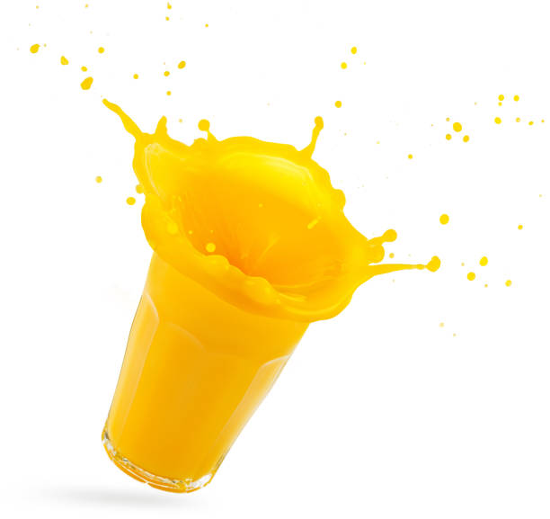 orange juice glass splashing on white