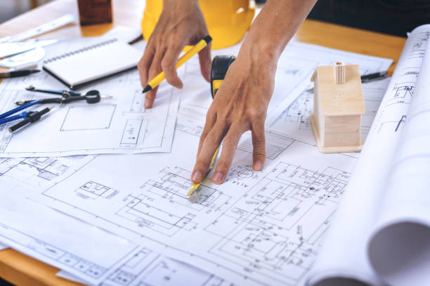 istock Close up of concentrated male engineer drawing hands working on architectural project at construction site at desk in office. 929024574