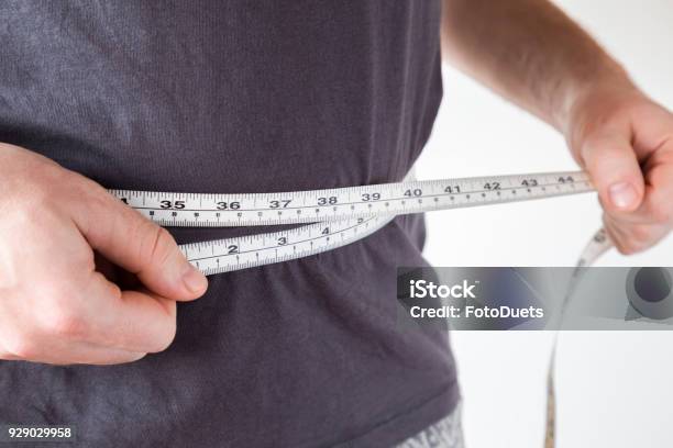 Slim Man Measuring His Waist Healthy Lifestyle Body Slimming Weight Loss Concept Cares About Body Stock Photo - Download Image Now