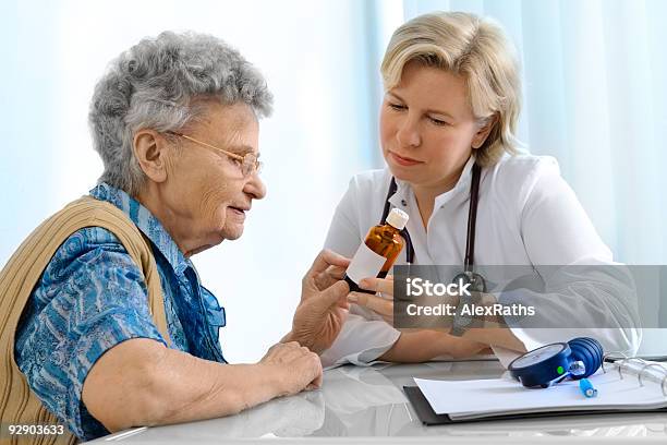 Doctor Explaining Prescription Medicine To Senior Female Stock Photo - Download Image Now