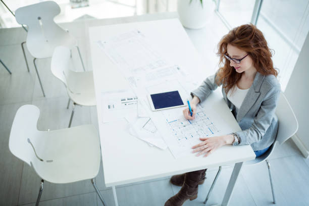 istock Beautiful businesswoman using tablet to gather information in of 929036618