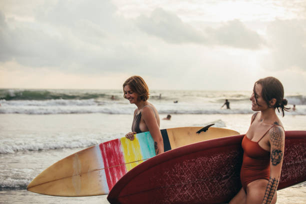 istock Women surfers at the beach 929043376