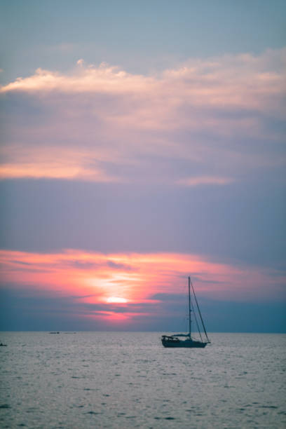 istock Romantic sunset with sailboat 929044386