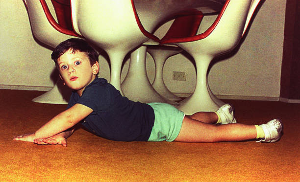 playful boy of the seventies at home - happy kid flash imagens e fotografias de stock