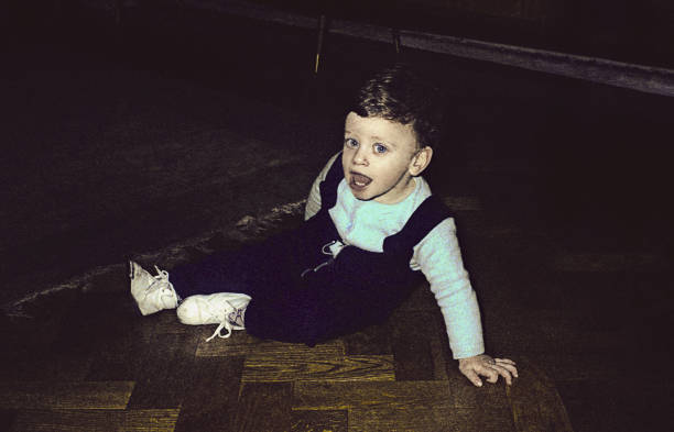 istock Joyful vintage toddler on floor looking at camera 929052634