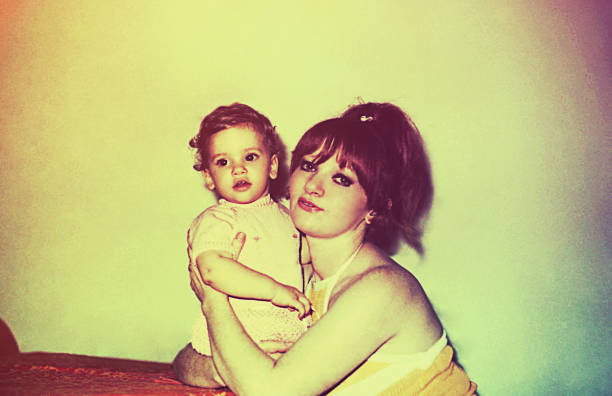 Vintage mother and daughter Vintage image of a mother hugging her little daughter. toned image photos stock pictures, royalty-free photos & images