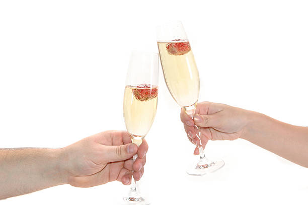 Young couple drinking Champagne in a VIP suite with room service