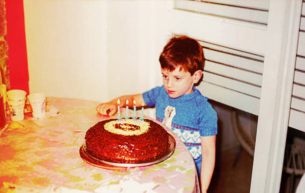 vintage photo of a boy with his birthday cake - very old flash imagens e fotografias de stock