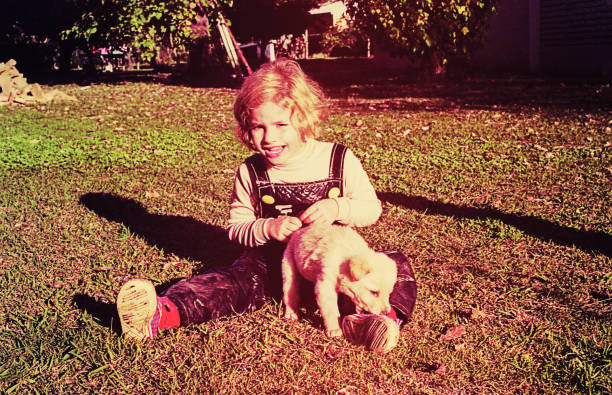 Vintage toddler with a puppy stock photo