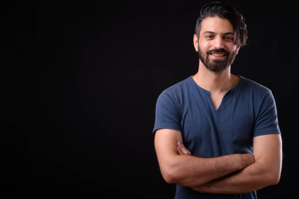 istock Portrait Of Handsome Man Smiling Against Black Background 929063728