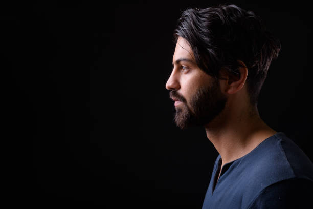 Portrait Of Handsome Man Against Black Background Studio Shot Of Handsome Man Against Black Background iranian ethnicity stock pictures, royalty-free photos & images