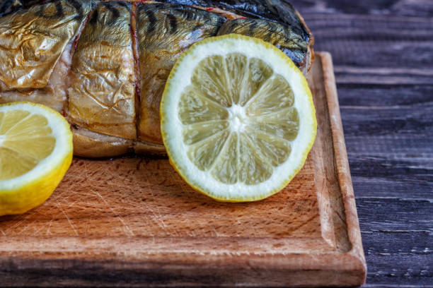 istock Smoked fish mackerel on a wooden background, close-up, top view. 929063872