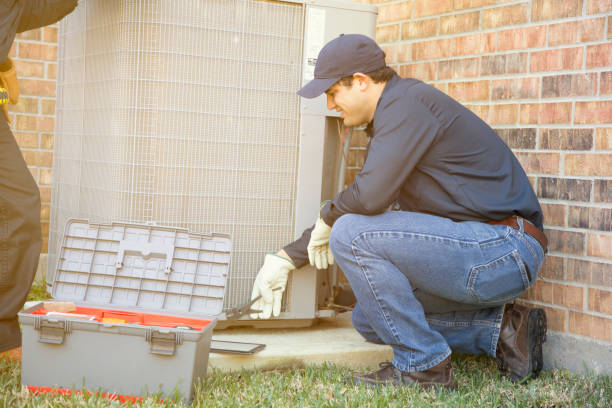 istock Multi-ethnic team of blue collar air conditioner repairmen at work. 929067962