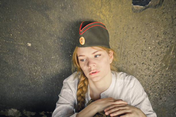 istock girl in uniform, crying, near an old dirty wall 929068406