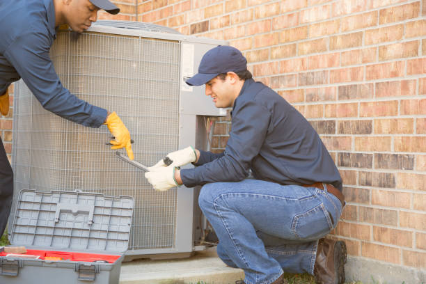 istock Multi-ethnic team of blue collar air conditioner repairmen at work. 929068450