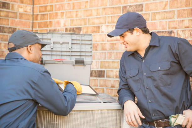 istock Multi-ethnic team of blue collar air conditioner repairmen at work. 929068516