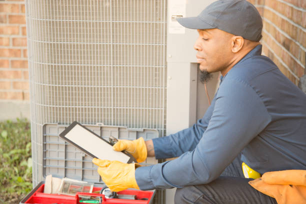 istock Blue collar air conditioner repairman at work. 929070746