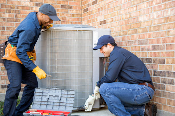Multi-ethnic team of blue collar air conditioner repairmen at work. Multi-ethnic team of blue collar air conditioner repairmen at work.  They prepare to begin work by gathering appropriate tools from their tool box. air conditioner photos stock pictures, royalty-free photos & images