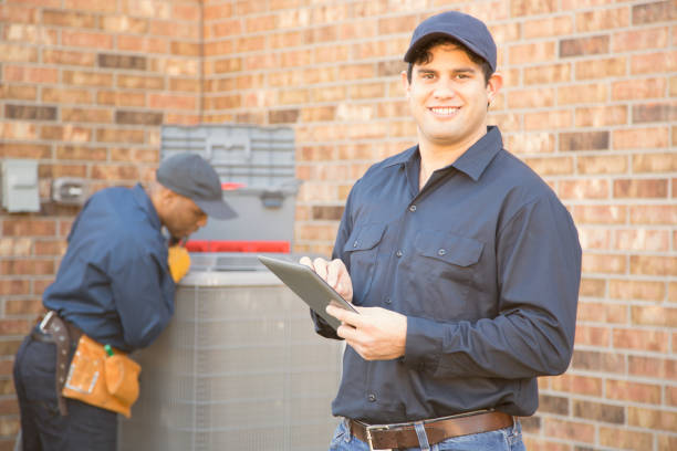 istock Multi-ethnic team of blue collar air conditioner repairmen at work. 929071004