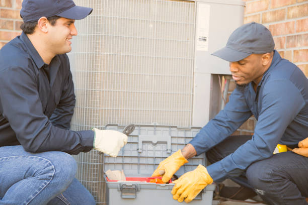istock Multi-ethnic team of blue collar air conditioner repairmen at work. 929071246
