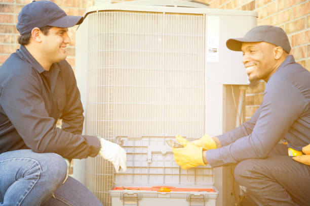 istock Multi-ethnic team of blue collar air conditioner repairmen at work. 929071328