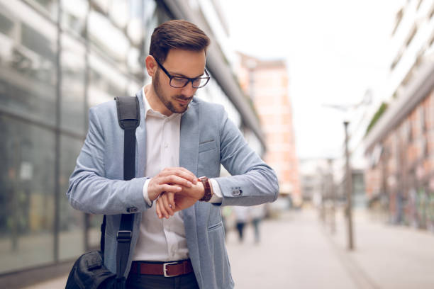 istock Businessman checking the time on his wristwatch 929078162
