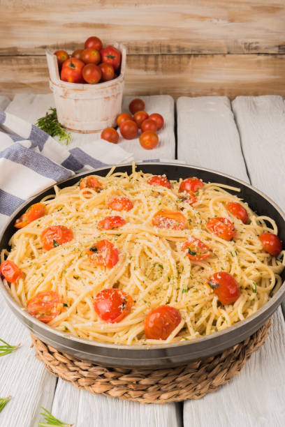 istock Spaghetti pasta with tomatoes and parsley on wooden table 929079704