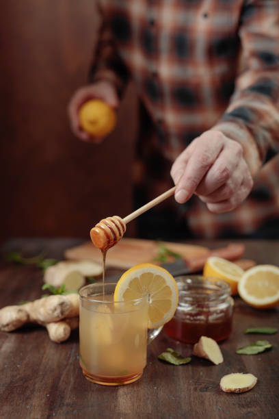 istock Ginger tea with honey , lemon and mint on old wooden table . 929082430