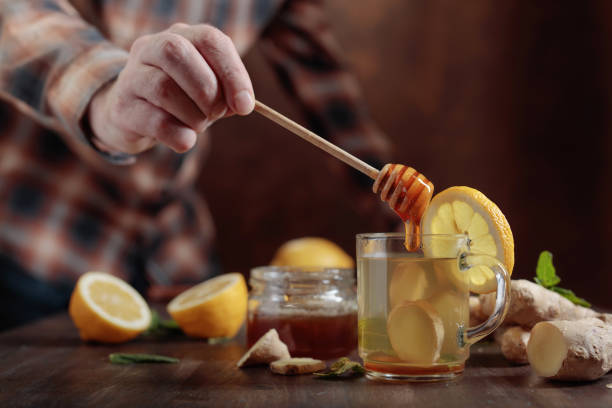 istock Ginger tea with honey , lemon and mint on old wooden table . 929082442