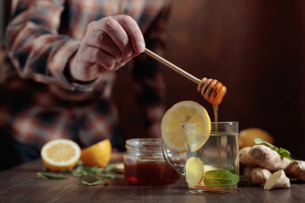 istock Ginger tea with honey , lemon and mint on old wooden table . 929082472