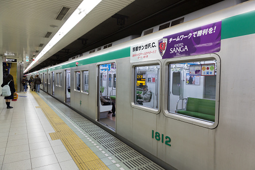 Kyoto, Japan - December 22, 2015 : Passengers at Kokusaikaikan Station in Kyoto, Japan. It is the metro network in the city of Kyoto, Japan.