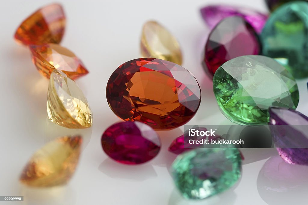 Close up of assorted laser cut gemstones Real gems including sapphires, emeralds, rubies, tanzanite and tourmaline. Tanzanite Stock Photo