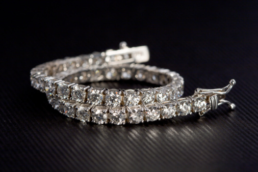 Diamond Tennis Bracelet set on a elegant black background.