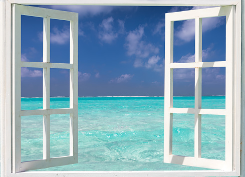 Summer holiday concept: window with view to turquoise waters and blue skies