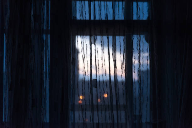 istock sunrise view through curtain of window. wake up time 929104486