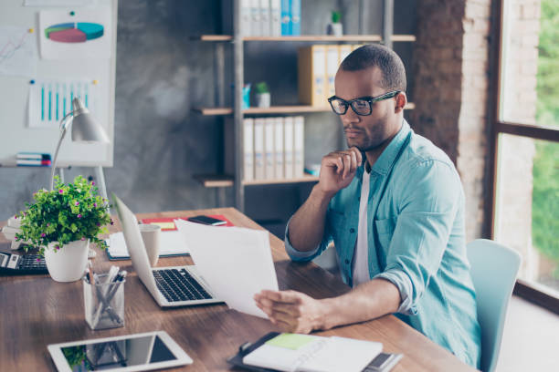 istock So nerd and focused. Young handsome afro student is concentrated on studying. He is in a casual outfit with project at his work station 929115746