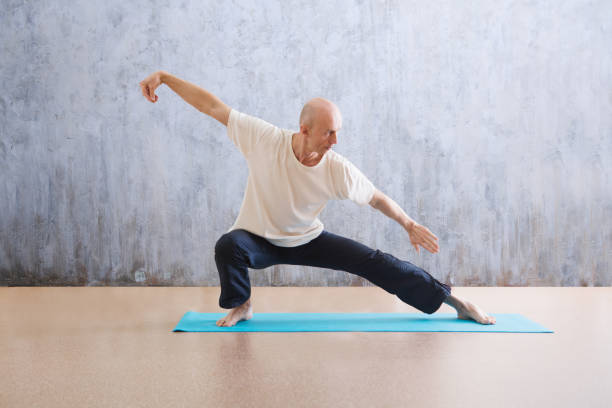man praticing tai chi chuan in the gym. Chinese management skill Qi's energy. WU-SHU. Man practice yoga stock photo