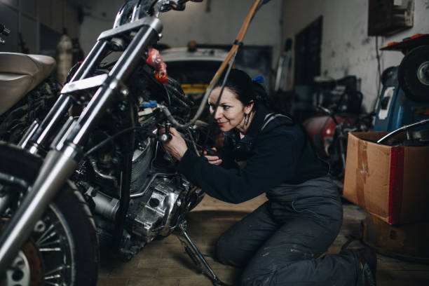 Man worker in motorcycle repair shop
