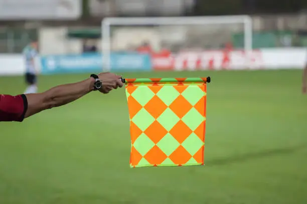 Soccer referee hold the flag. Offside trap