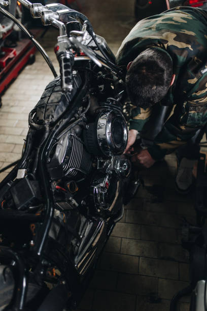 istock Man worker in motorcycle repair shop 929139846